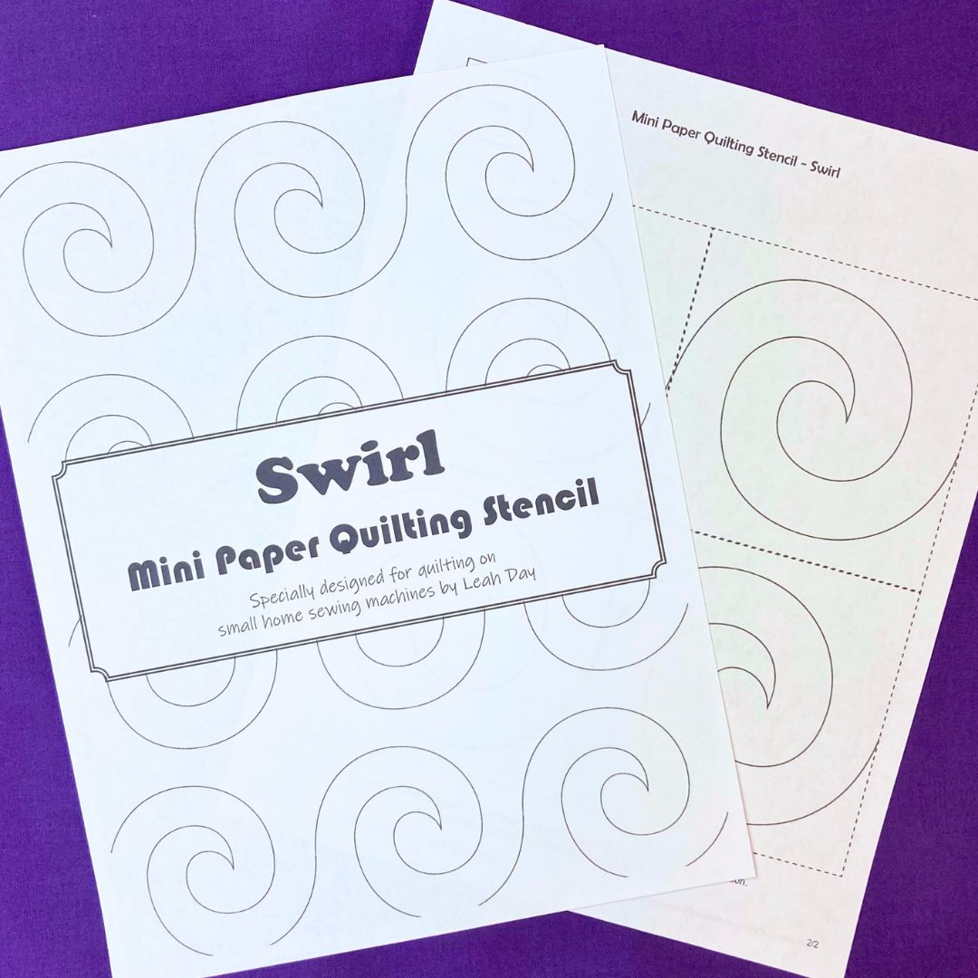Two mini paper quilting stencils with swirl patterns on a purple background