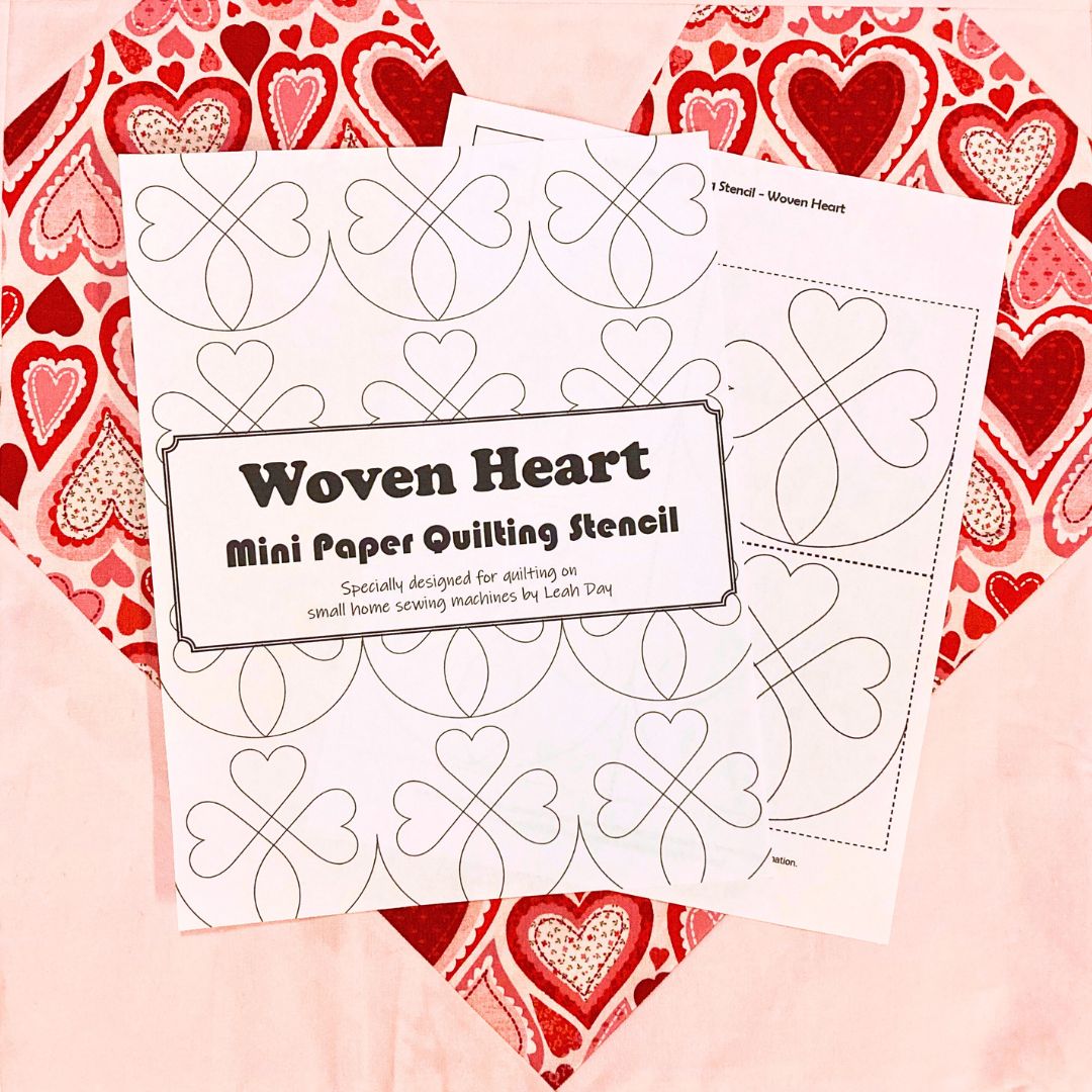 Woven Heart mini paper quilting stencil on a heart-patterned background