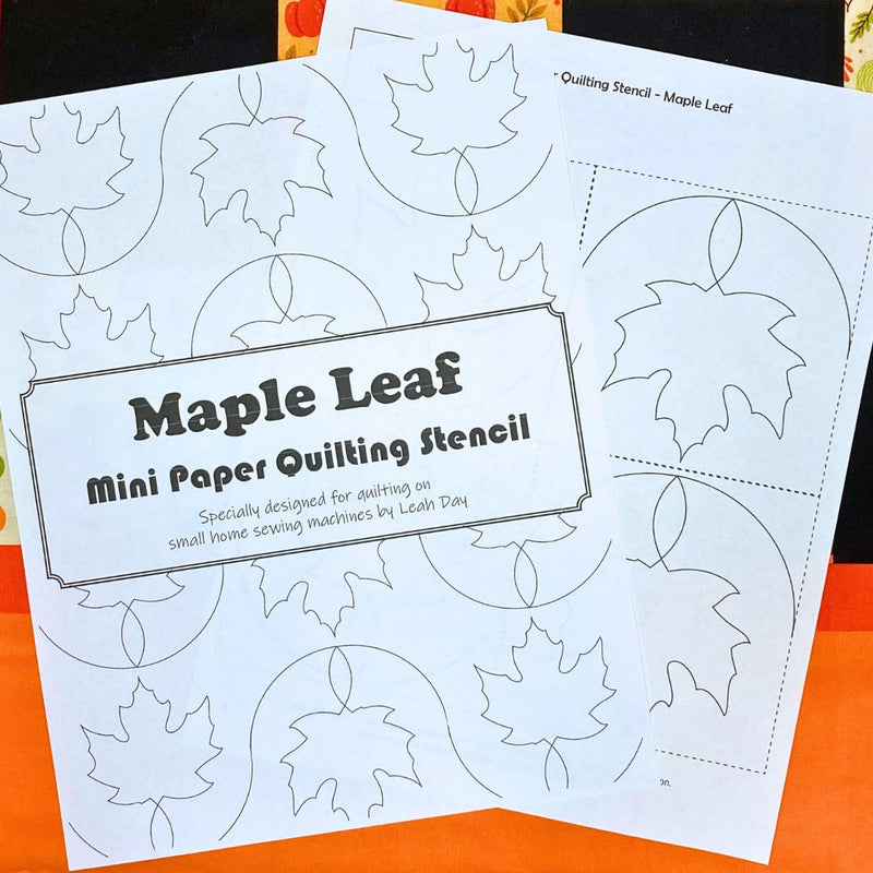 Maple leaf mini paper quilting stencil on a fall quilt background