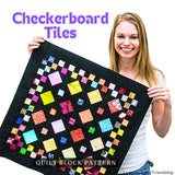 Leah Day holding a quilt block with a checkerboard tile pattern