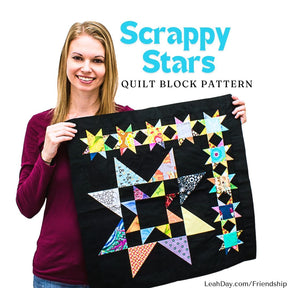 Leah Day holding a Scrappy Stars Friendship Sampler quilt block with colorful stars on a black background