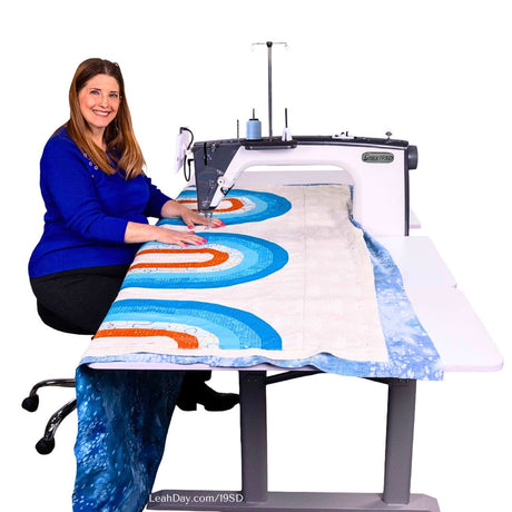 Grace 19SD long arm quilting machine with woman quilting blue and white quilt