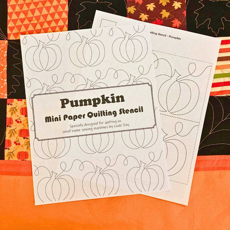 Pumpkin mini paper quilting stencil on a autumn quilt background