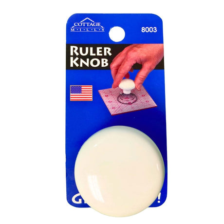 White ruler knob in blue packaging with quilting ruler handle in use