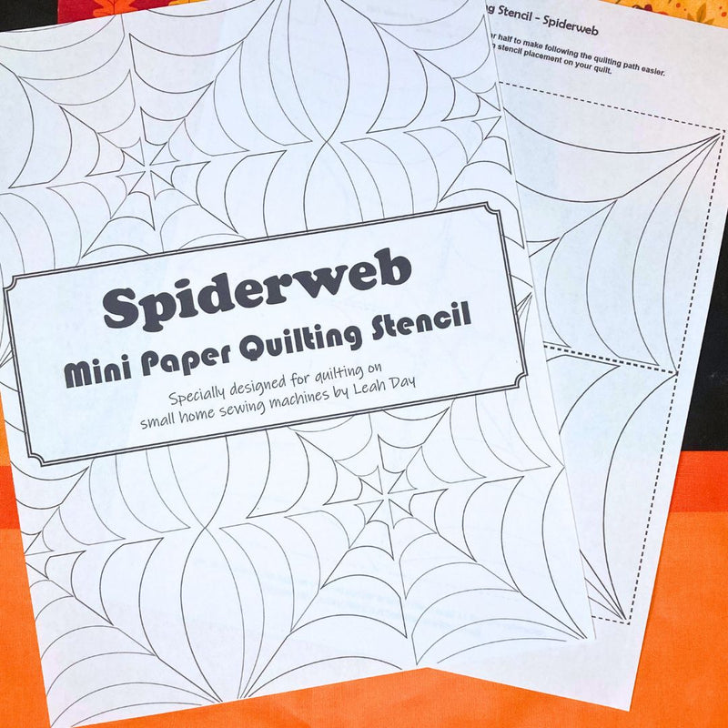 Spiderweb mini paper quilting stencil on an orange background